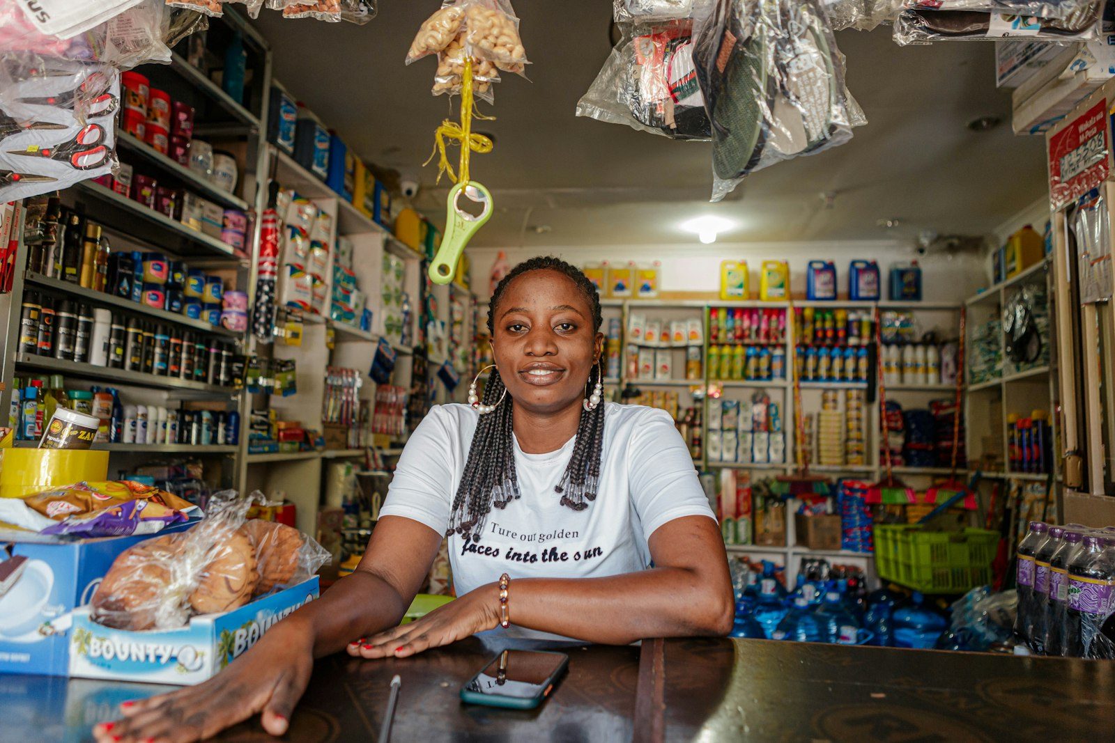 A shop owner standing at her counter